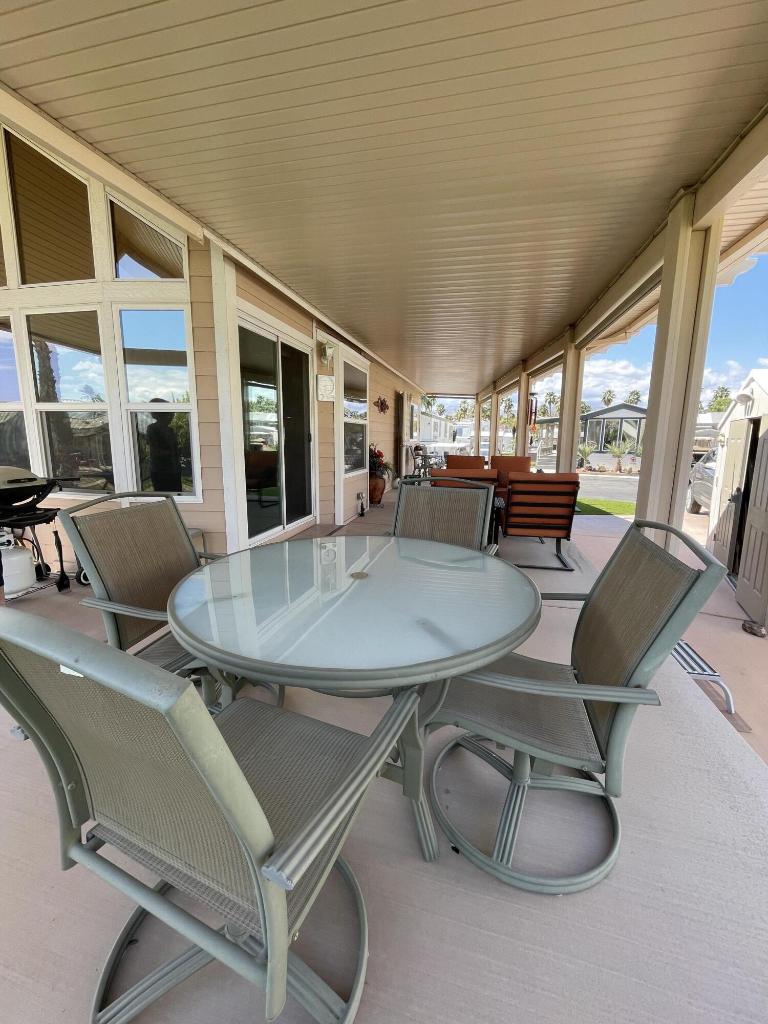 81620 Ave 49, Unit 235B Indio, CA 92201 - Photo 16 of 21 a view of a dining room with furniture and window