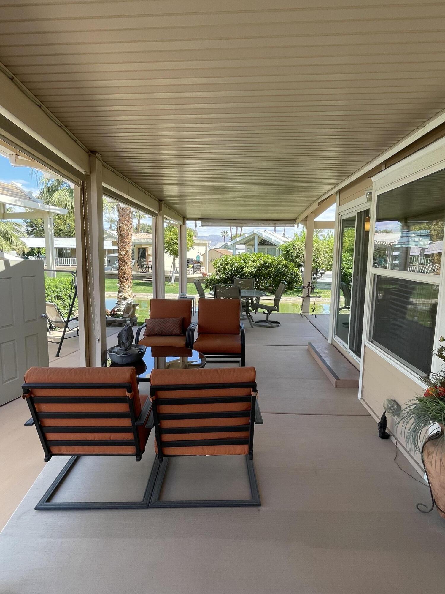 81620 Ave 49, Unit 235B Indio, CA 92201 - Photo 19 of 21 a backyard view with two chairs and a potted plant