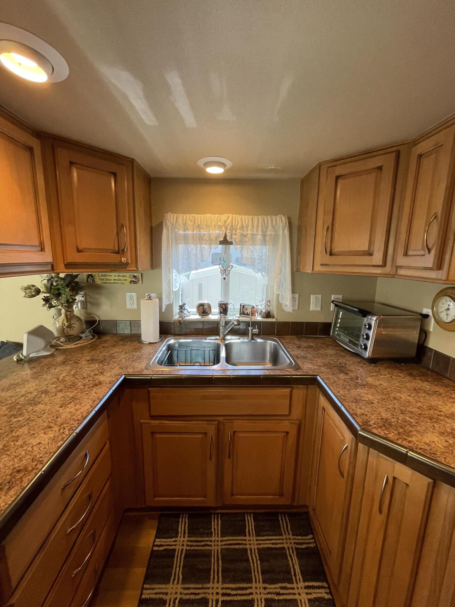 81620 Ave 49, Unit 235B Indio, CA 92201 - Photo 3 of 21 a kitchen with a sink a stove cabinets and a counter top space