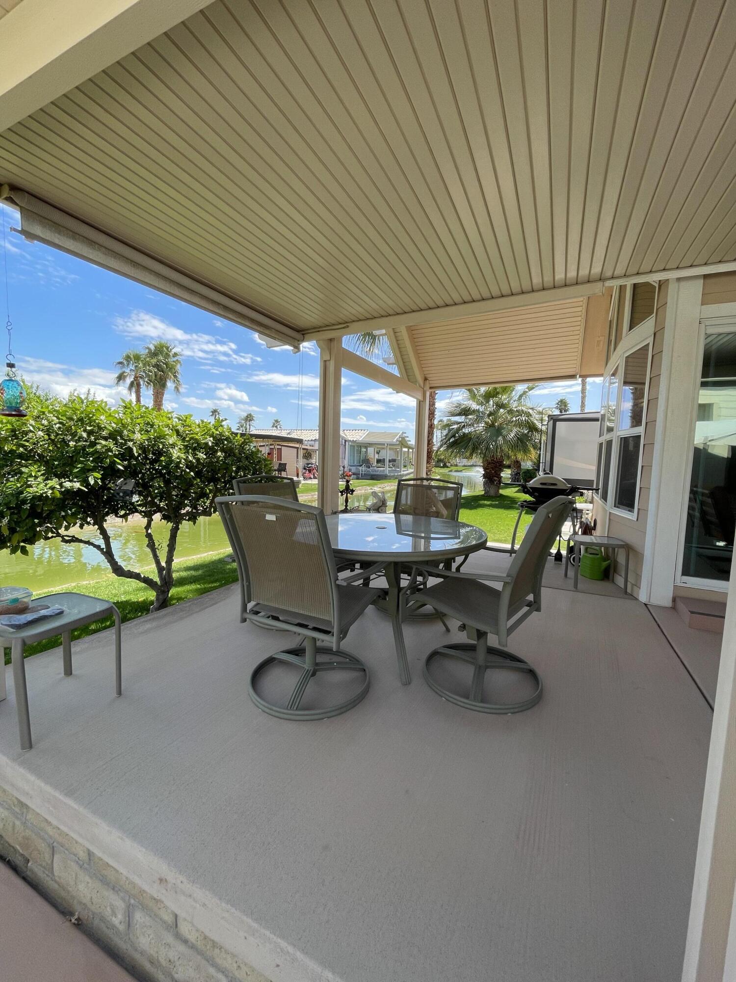81620 Ave 49, Unit 235B Indio, CA 92201 - Photo 9 of 21 a view of a patio with chairs and table in patio