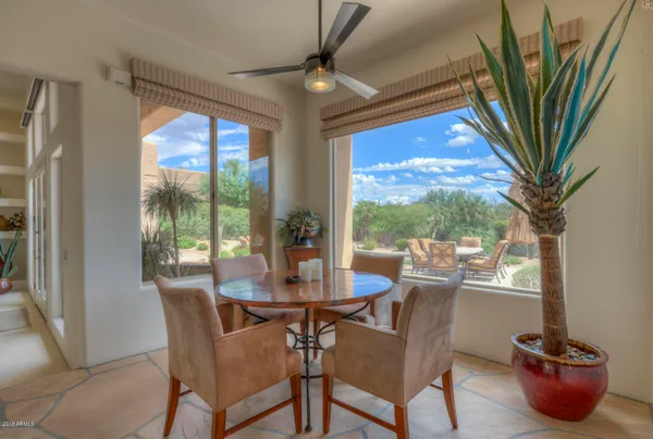 a dining room with furniture wooden floor and a potted plant