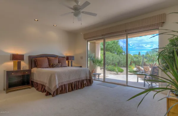 a spacious bedroom with a bed and large window