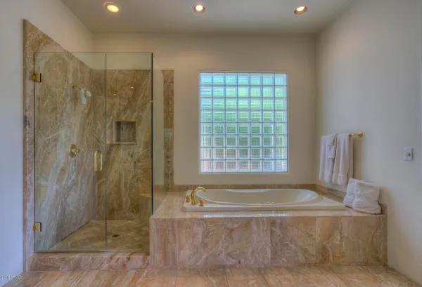 a bathroom with a bathtub and shower