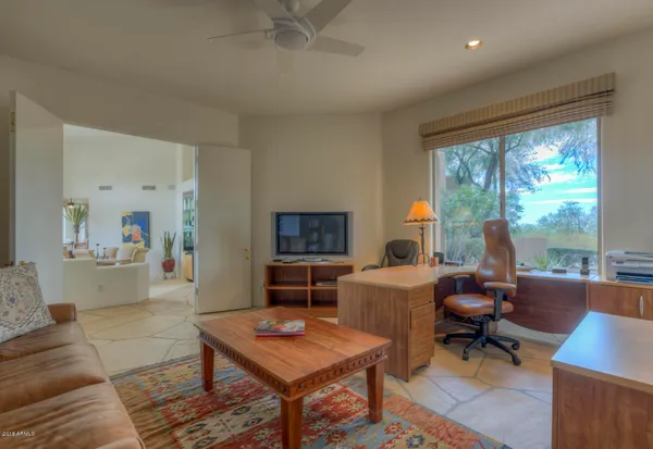 a living room with furniture a table and a large window