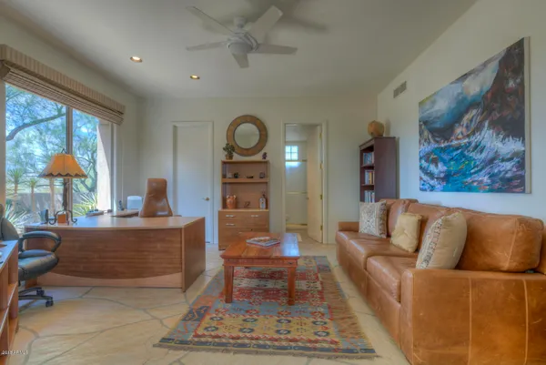 a living room with furniture a rug and a large window