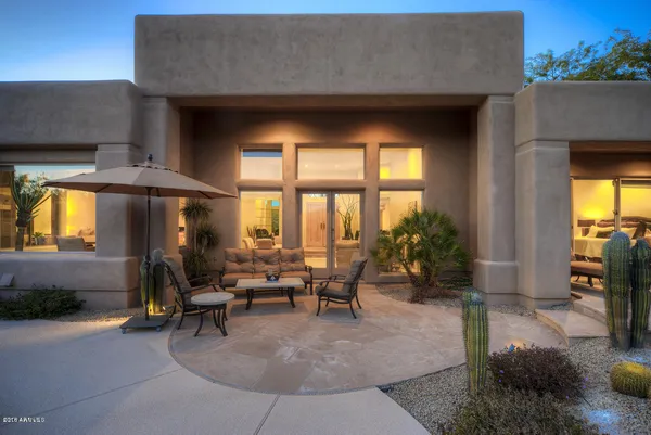 a view of a patio with dining table and chairs with a fire pit