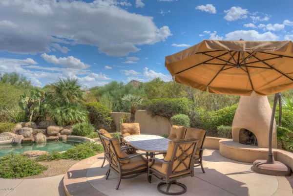 a view of a lake with lawn chairs