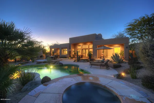 a swimming pool with outdoor seating and yard
