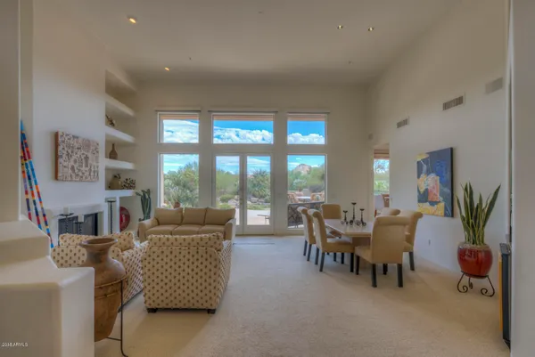 a living room with furniture and a floor to ceiling window