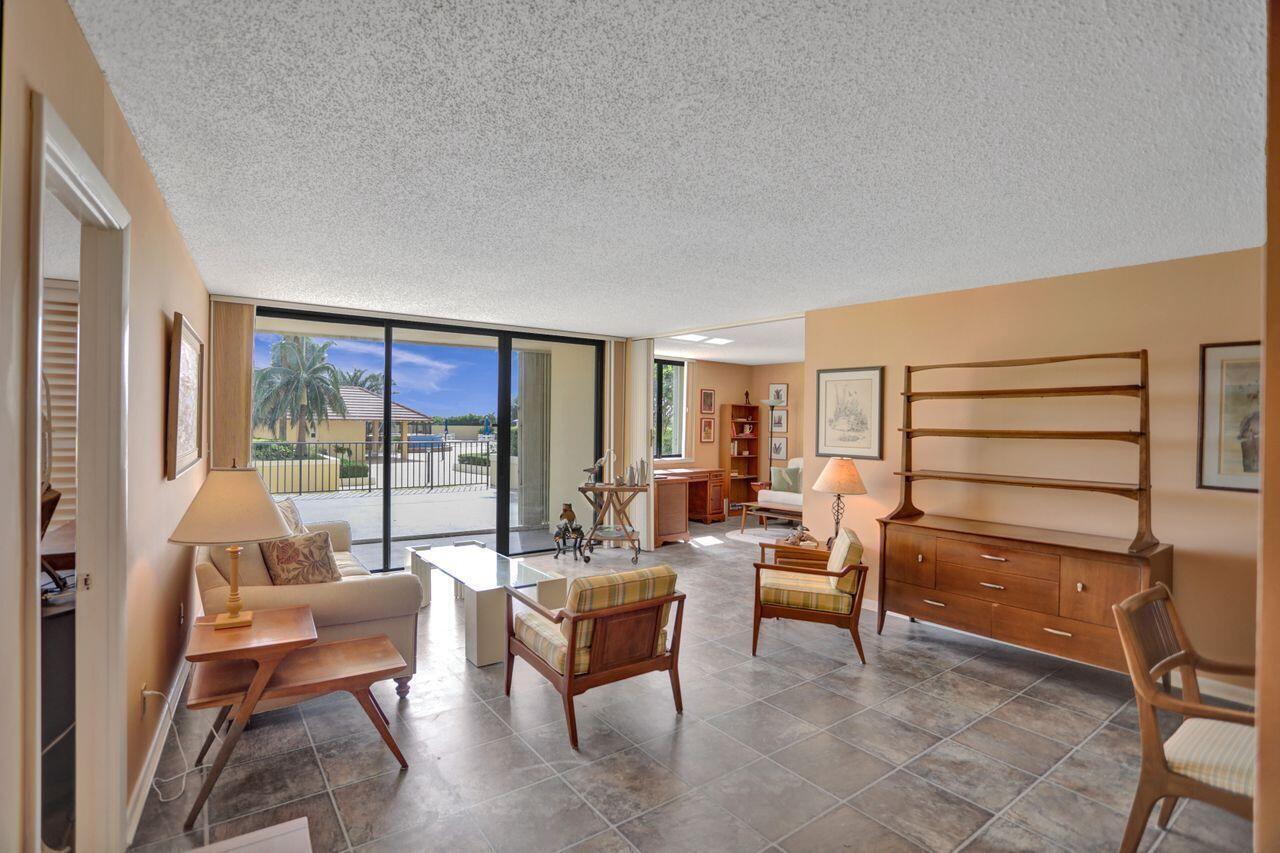 100 Ocean Trail Way, Unit 109 Jupiter, FL 33477 - Photo 2 of 27 a living room with furniture and a window