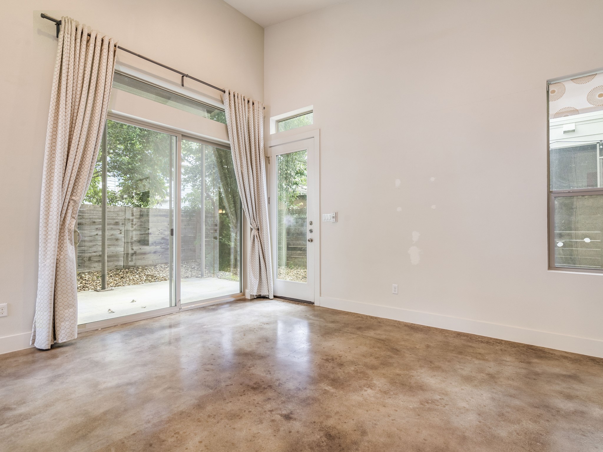1404 Singleton Avenue, Unit B Austin, TX 78702 - Photo 11 of 21 Natural light pours into this room, highlighting the polished concrete flooring.
