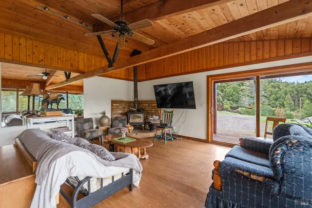 a bedroom with furniture and a large window