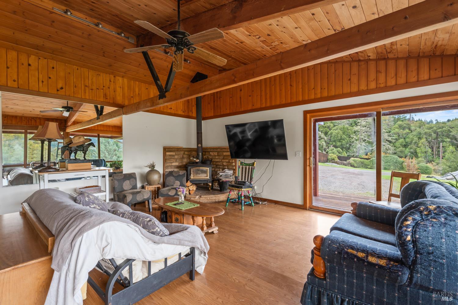 13800 Poonkinney Road Dos Rios, CA 95429 - Photo 24 of 28 a bedroom with furniture and a large window