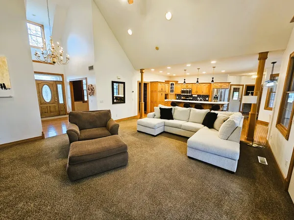 a living room with furniture and a chandelier