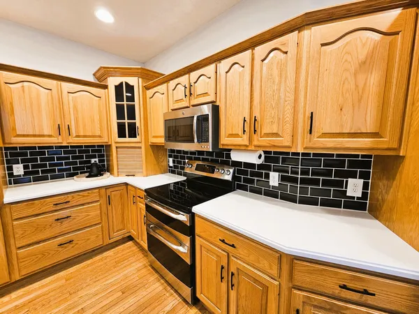 a kitchen with stainless steel appliances a stove and a microwave
