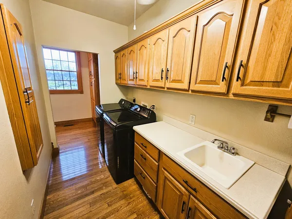 a kitchen with a sink a stove and cabinets