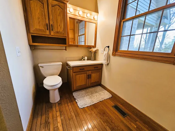 a bathroom with a toilet a sink and a mirror