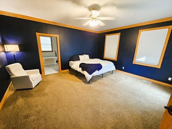 a bedroom with a bed couch and window