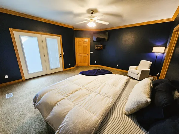 a bedroom with a bed and a chandelier