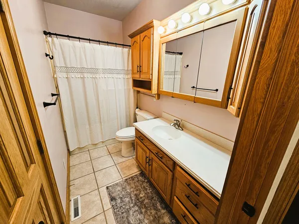 a bathroom with a sink a mirror and a shower curtain