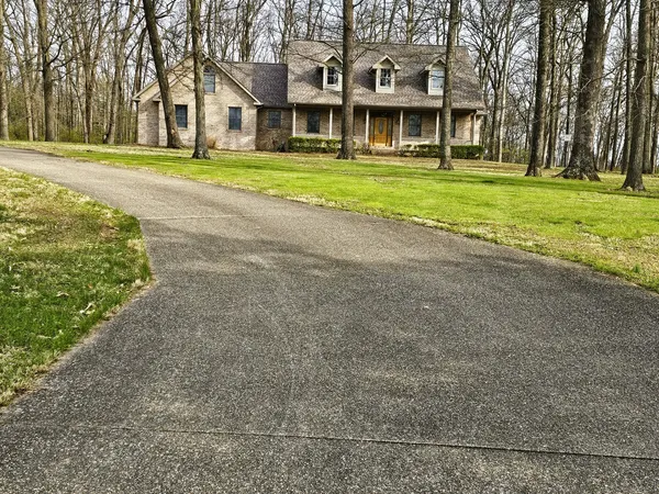 a view of house with a yard