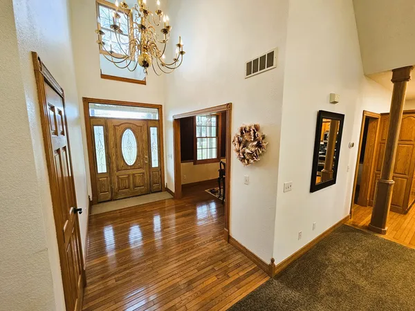 a view of an entryway with wooden floor