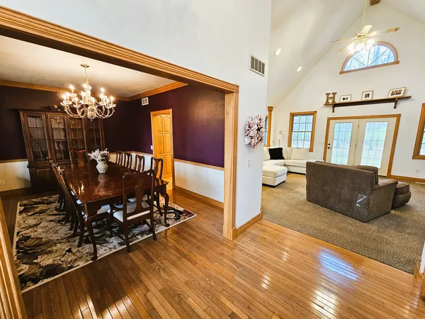 a living room with furniture and a chandelier