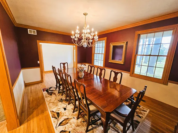 a view of a dining room with furniture and chandelier