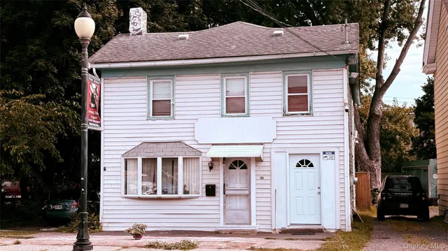 a front view of a house with a garden