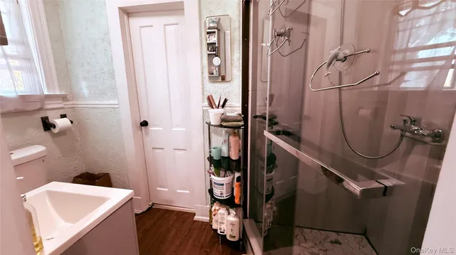 a bathroom with a sink a toilet and shower curtain