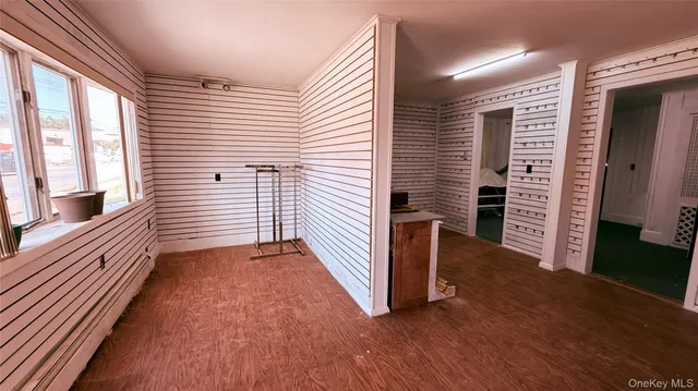 a view of a hallway with stairs and a wooden floor