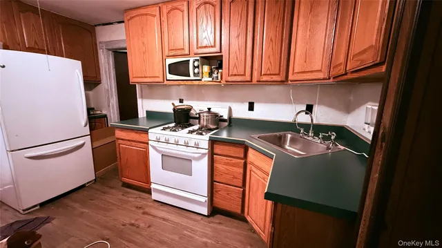 a kitchen with a refrigerator sink and cabinets