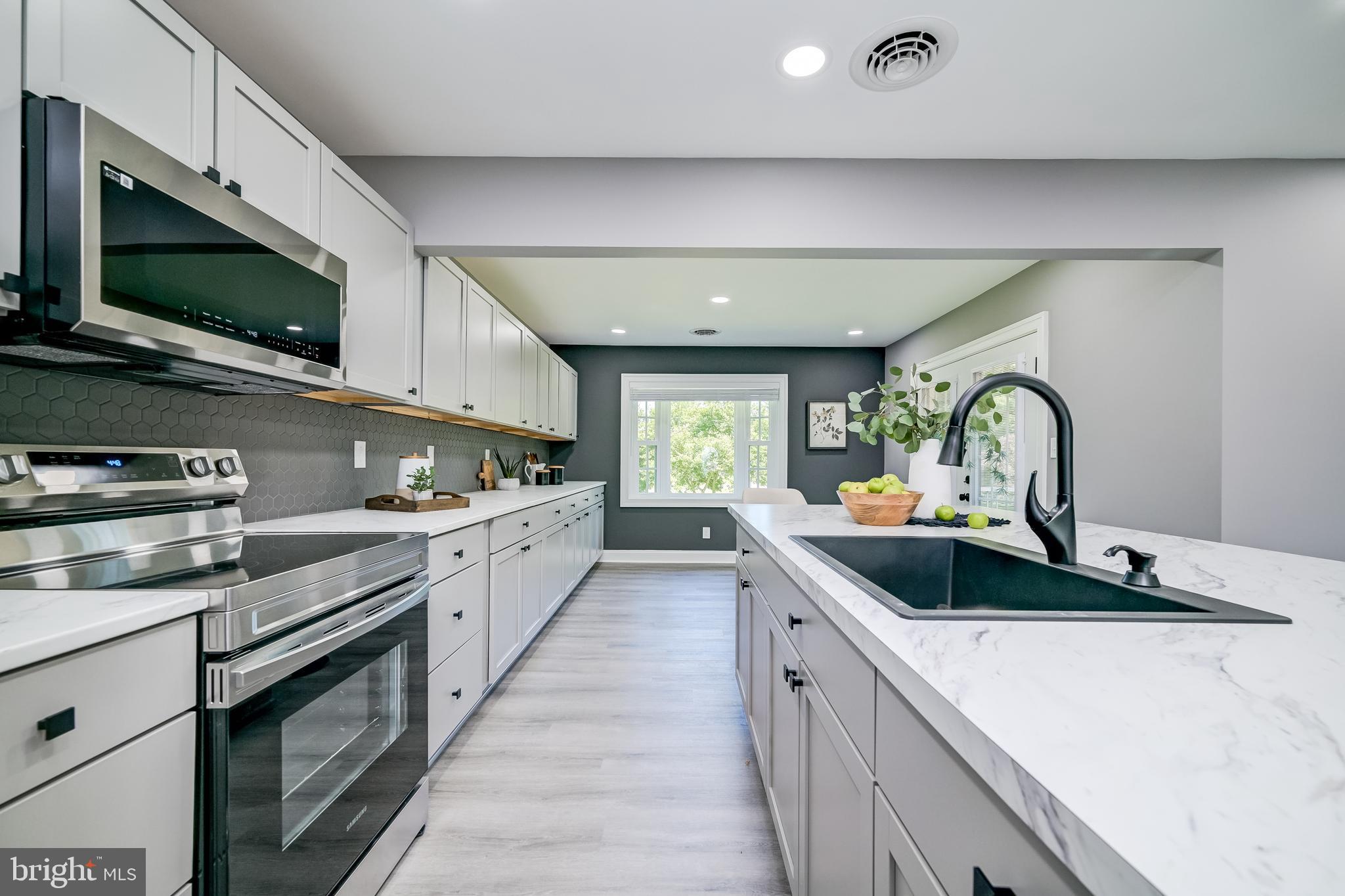 21020 Peach Tree Road Dickerson, MD 20842 - Photo 13 of 57 a kitchen with stainless steel appliances granite countertop a sink and stove top oven