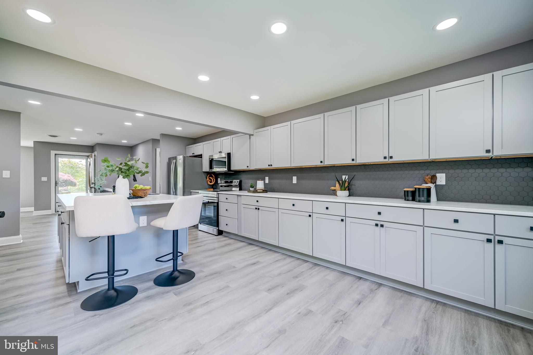 21020 Peach Tree Road Dickerson, MD 20842 - Photo 16 of 57 a kitchen with sink cabinets and wooden floor