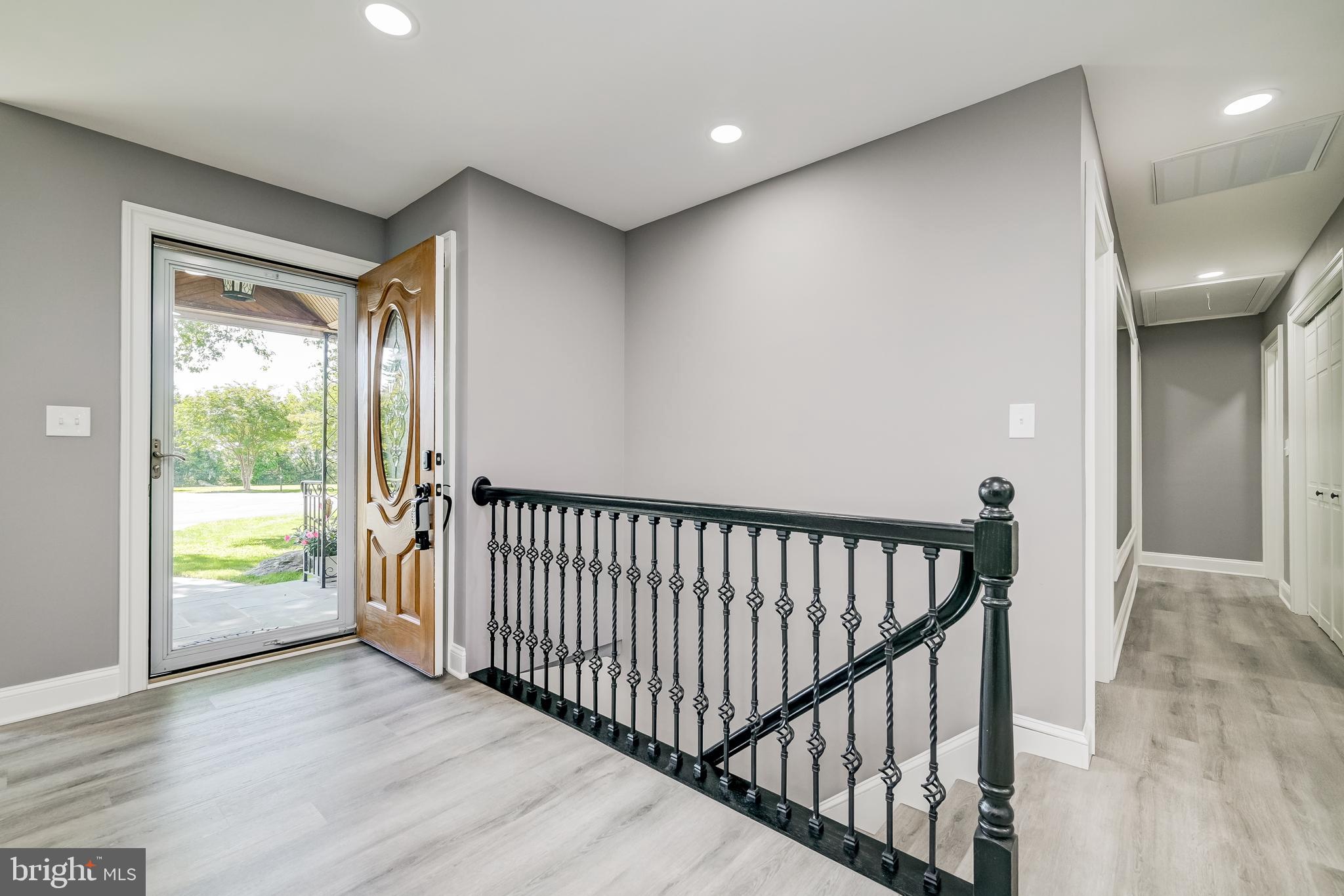 21020 Peach Tree Road Dickerson, MD 20842 - Photo 33 of 57 a view of a hallway with wooden floor and a bathroom