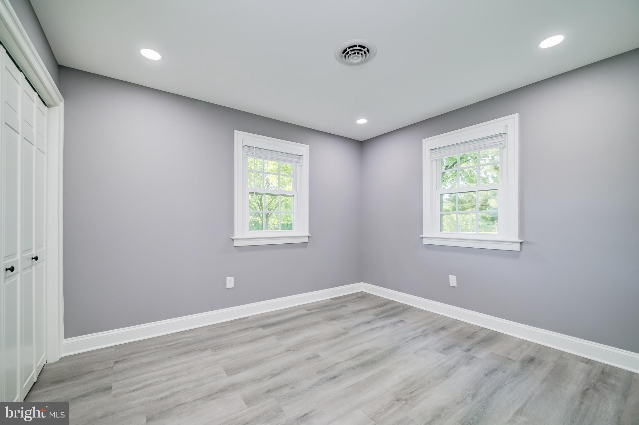 21020 Peach Tree Road Dickerson, MD 20842 - Photo 36 of 57 an empty room with wooden floor and windows