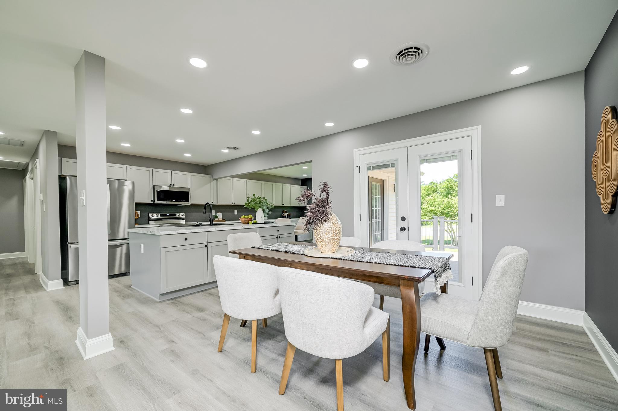21020 Peach Tree Road Dickerson, MD 20842 - Photo 9 of 57 a kitchen with kitchen island wooden cabinets and stainless steel appliances
