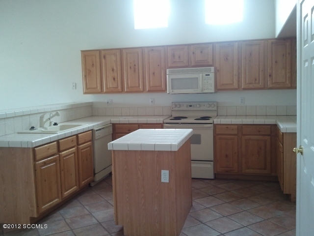 92 Back Nine Terrace Rio Rico, AZ 85648 - Photo 2 of 10 a utility room with a sink a washer and dryer