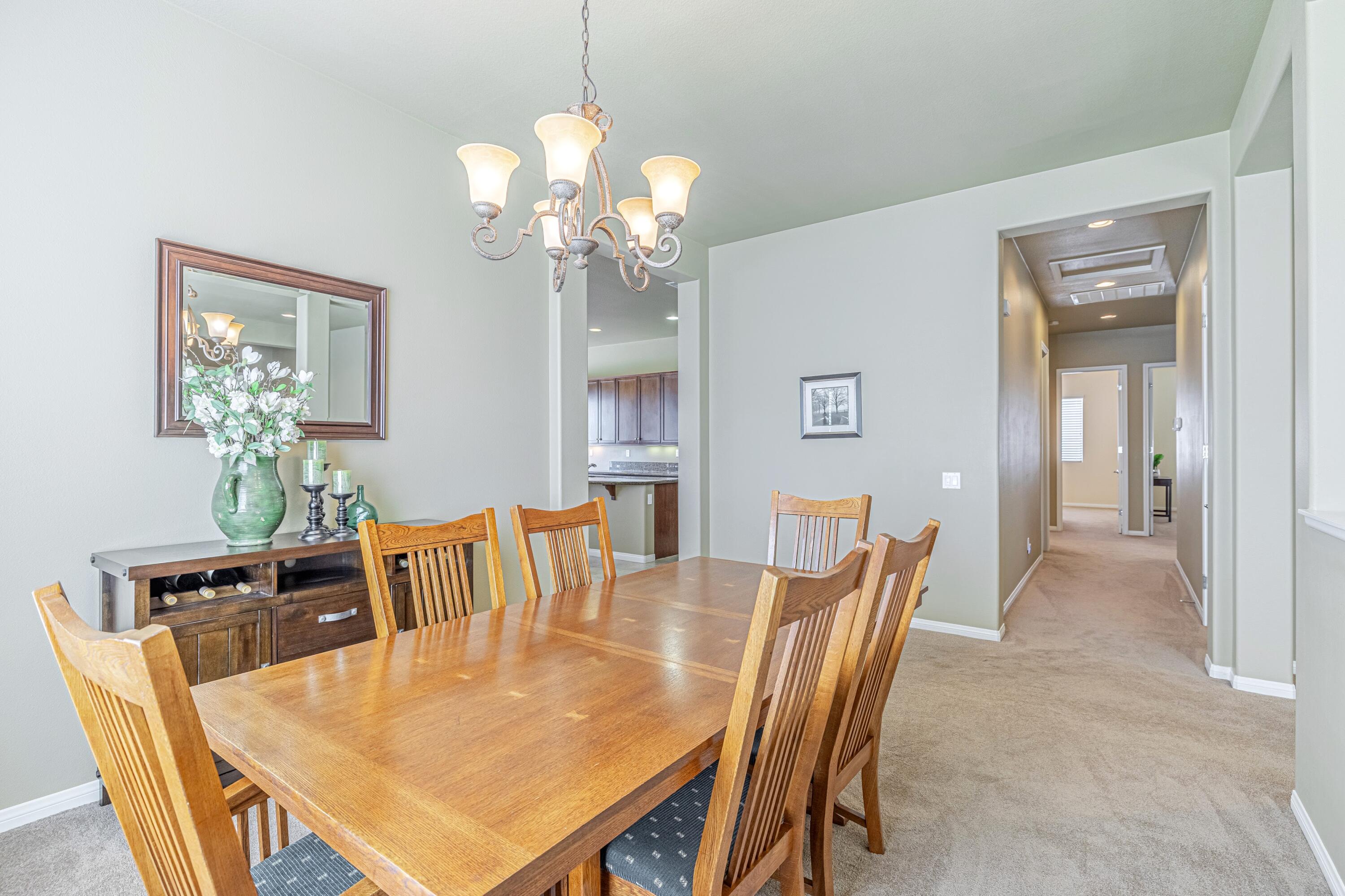 6853 Cabernet Road Palmdale, CA 93551 - Photo 14 of 42 a dining room with furniture a chandelier and window