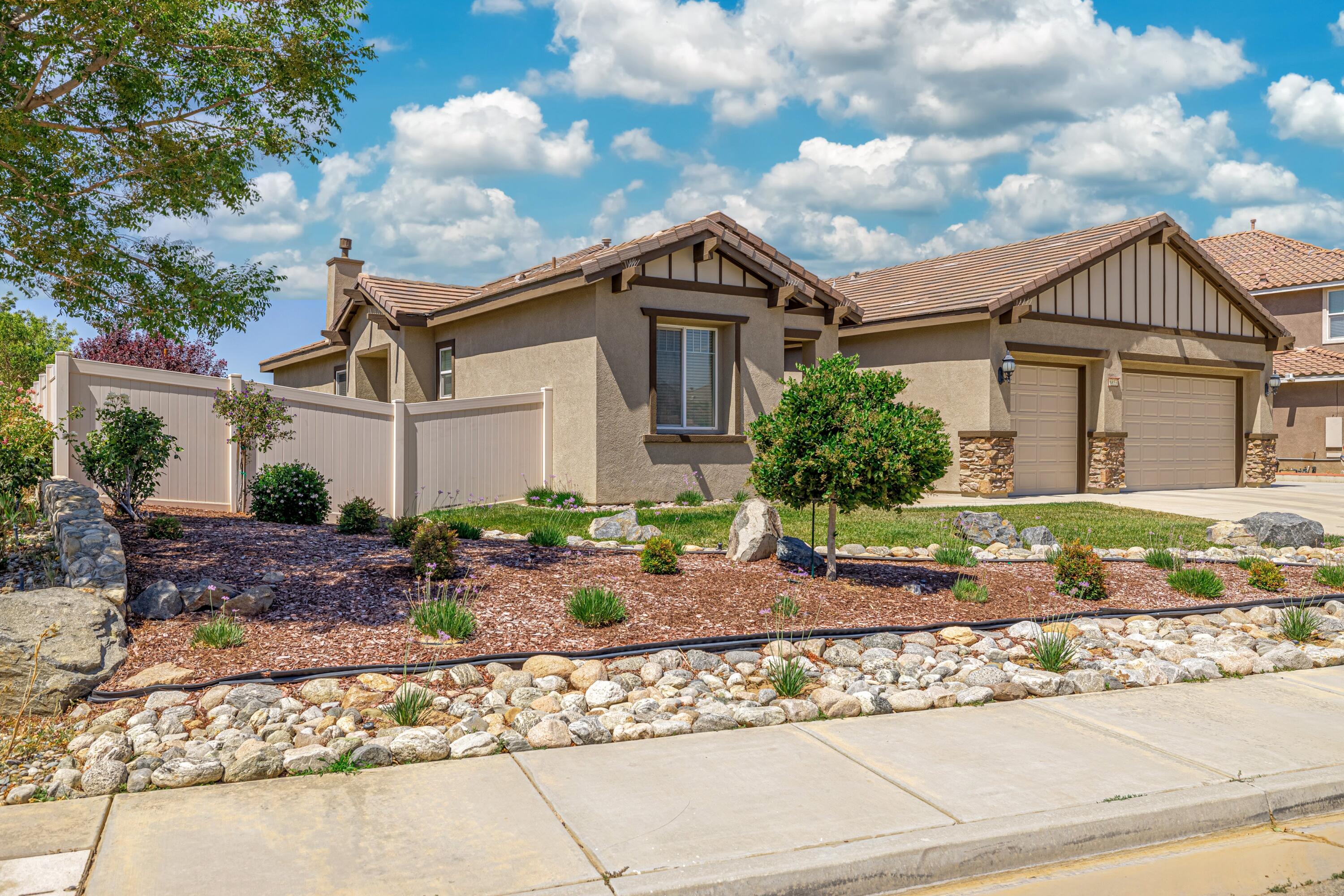 6853 Cabernet Road Palmdale, CA 93551 - Photo 3 of 42 a front view of a house with garden