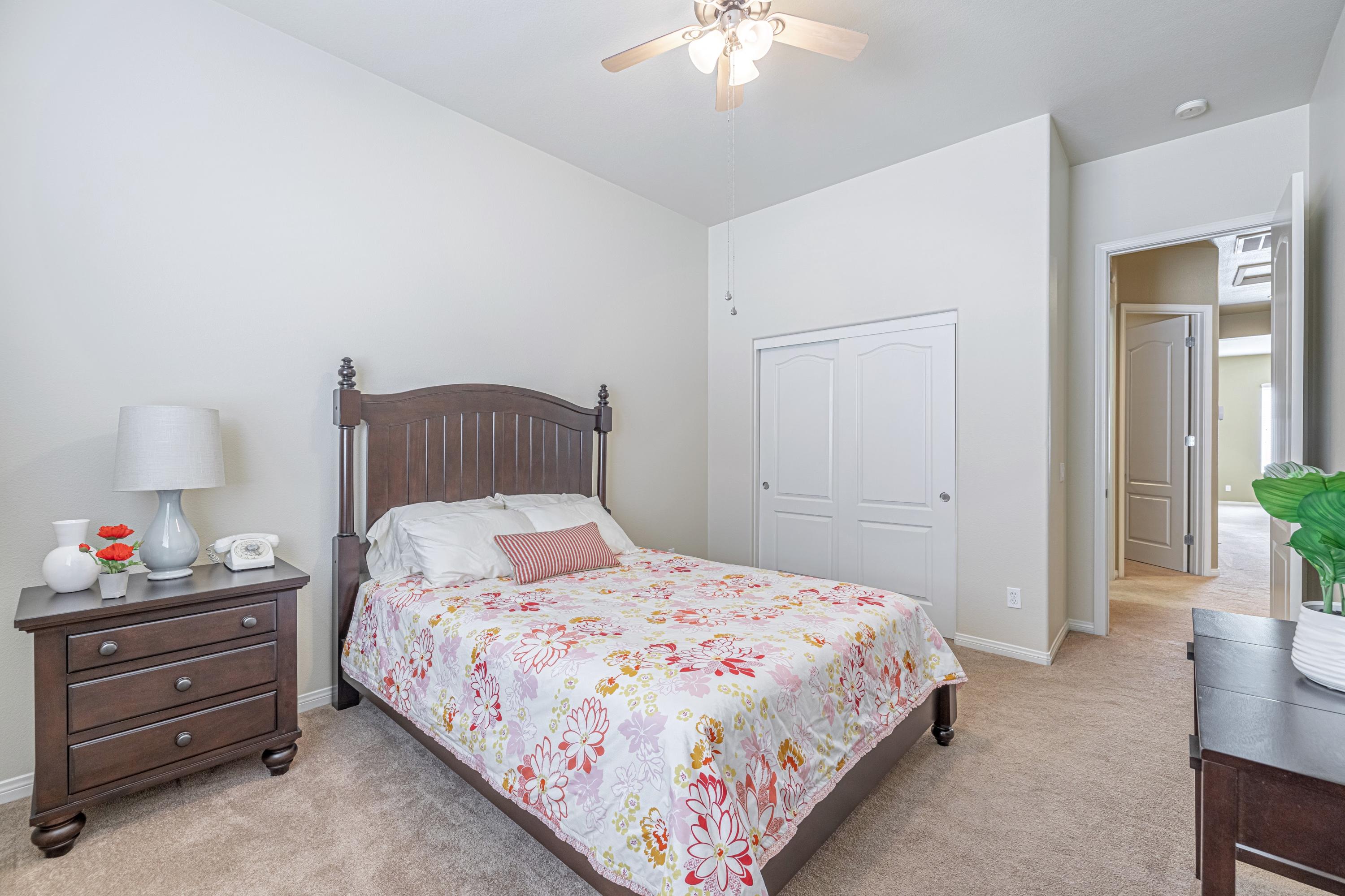 6853 Cabernet Road Palmdale, CA 93551 - Photo 29 of 42 a bedroom with a bed and a chandelier