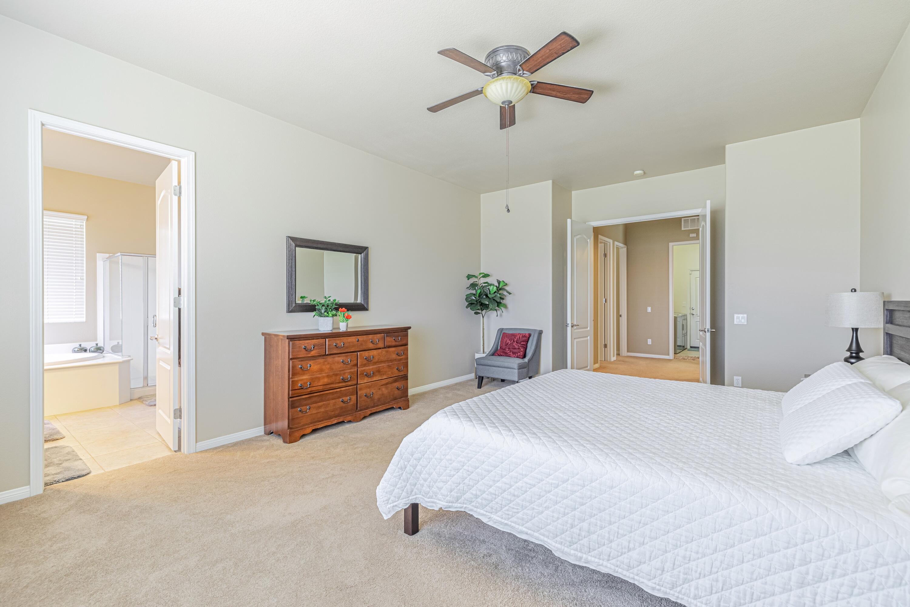 6853 Cabernet Road Palmdale, CA 93551 - Photo 33 of 42 a bedroom with a bed and a chandelier