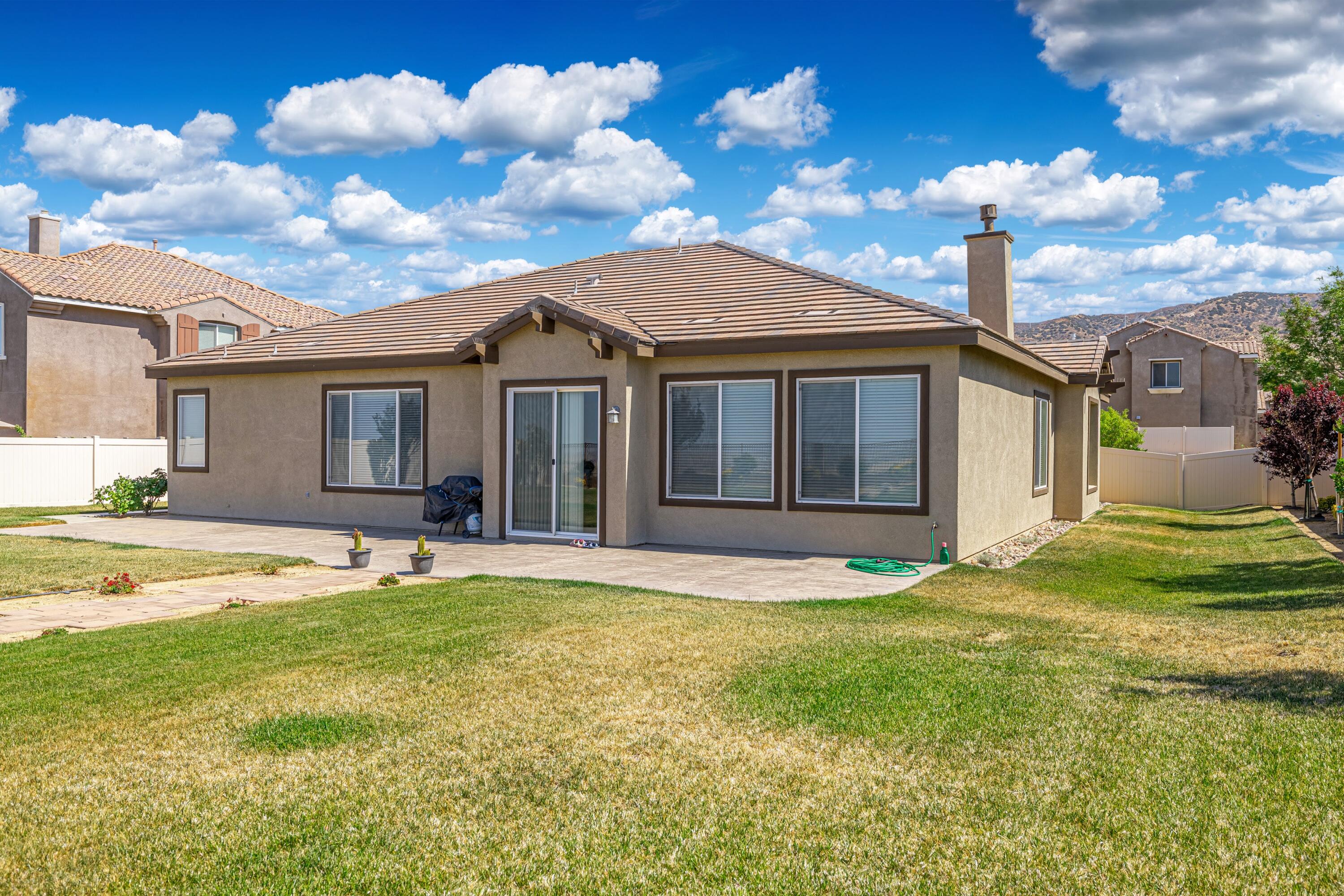 6853 Cabernet Road Palmdale, CA 93551 - Photo 40 of 42 a view of a house with a yard and a large tree