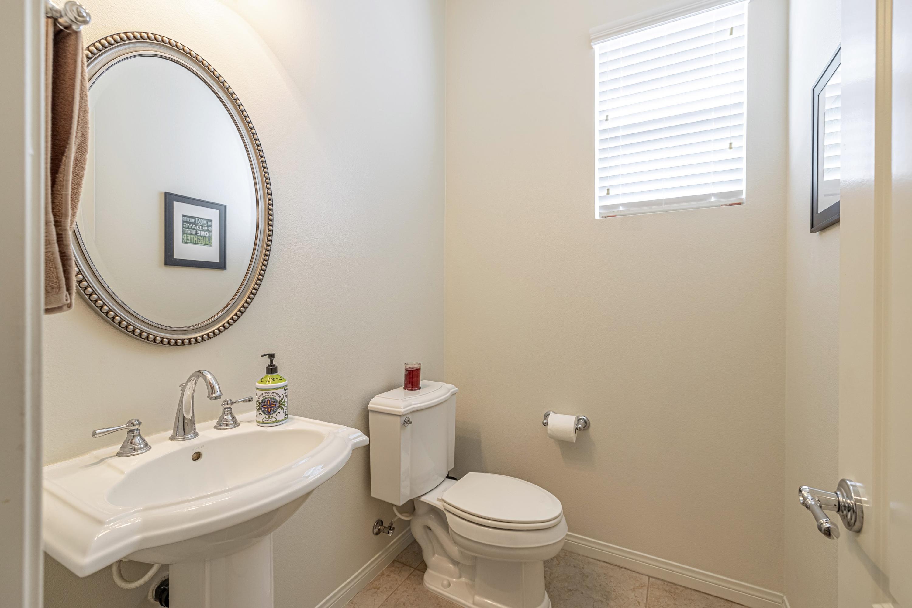 6853 Cabernet Road Palmdale, CA 93551 - Photo 7 of 42 a bathroom with a sink a mirror and a toilet