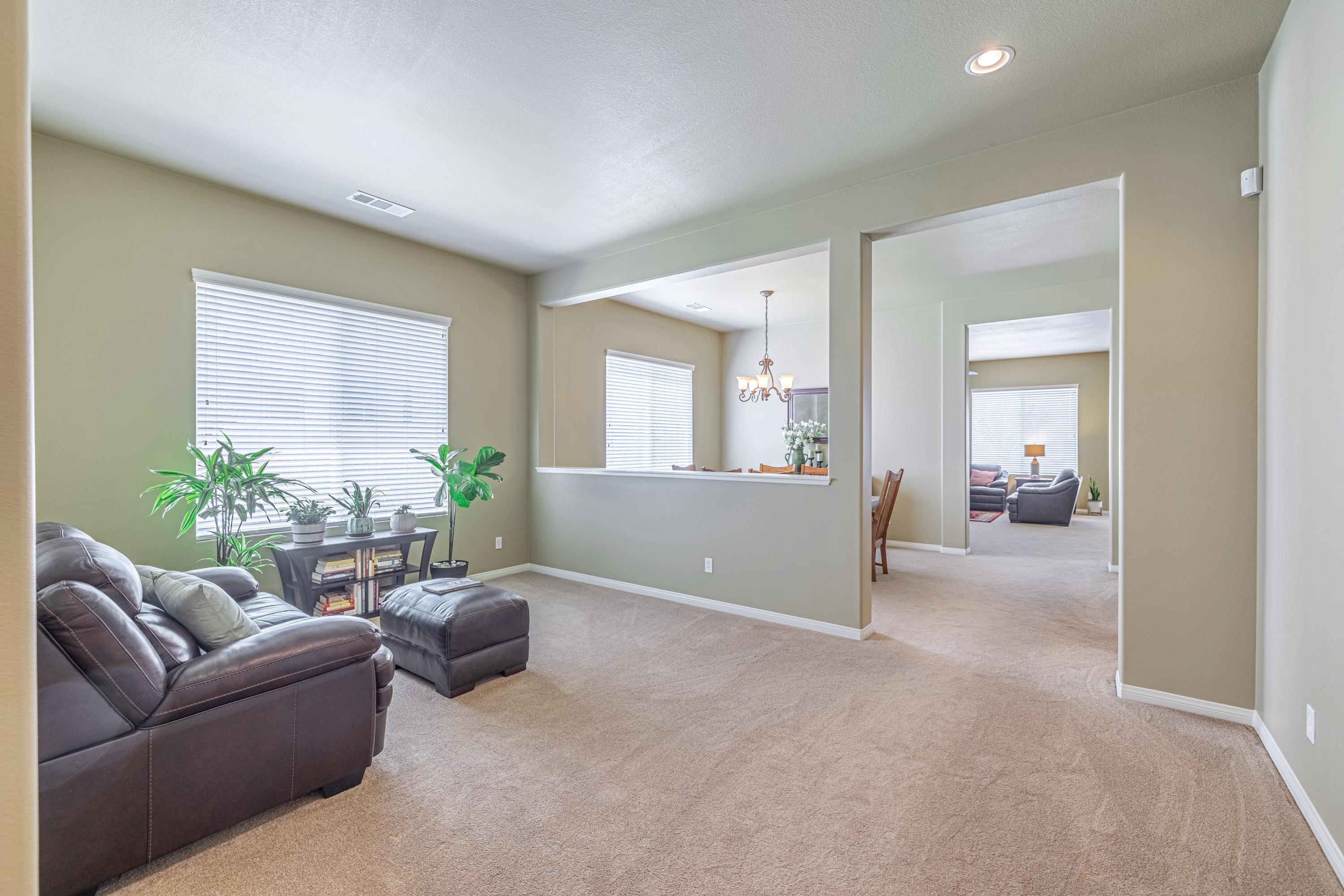 6853 Cabernet Road Palmdale, CA 93551 - Photo 10 of 42 a living room with furniture and a potted plant