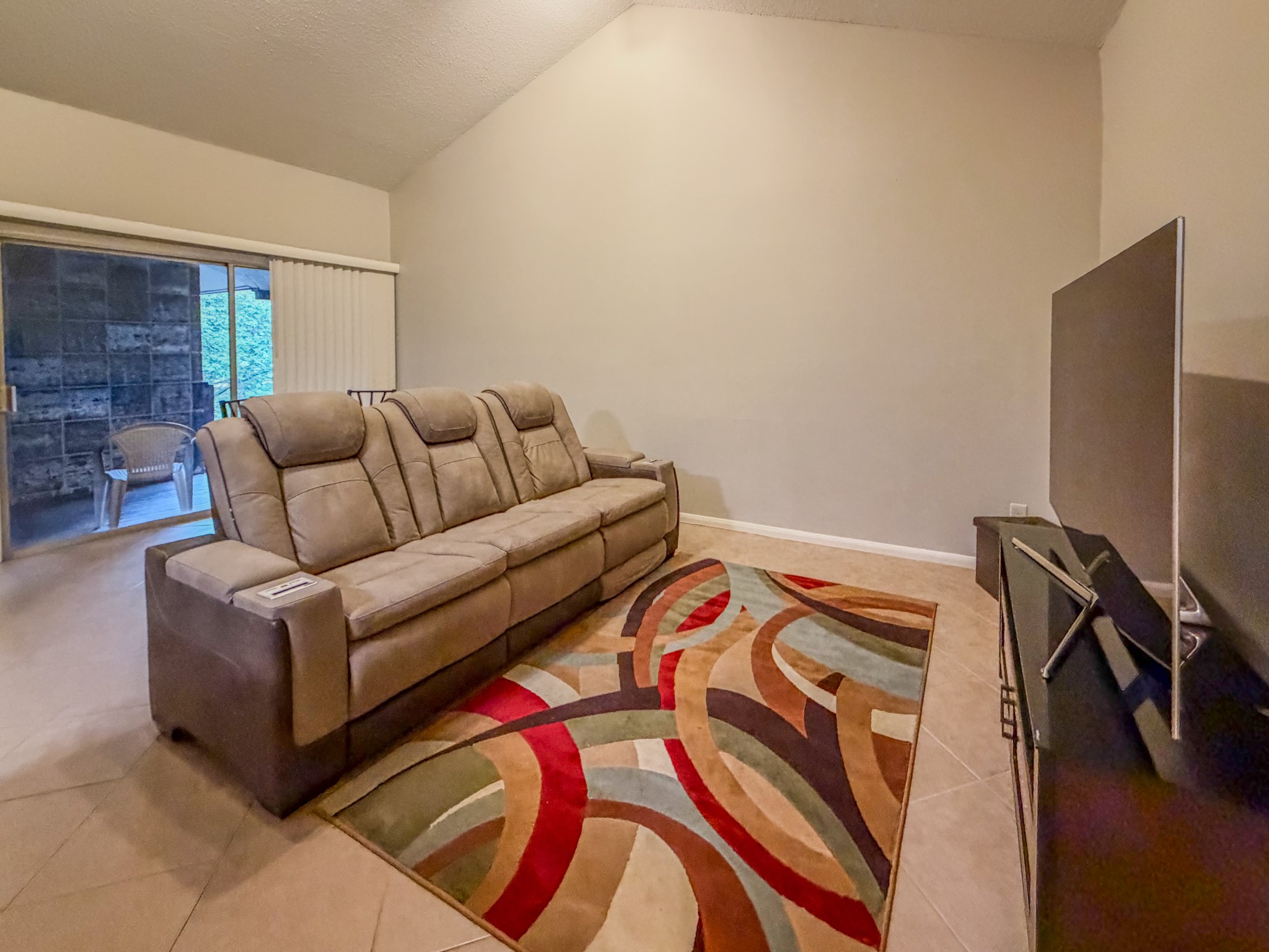 2574 Marilee Lane, Unit 23 Houston, TX 77057 - Photo 2 of 22 Relax in your luxurious three-seat power-reclining sofa equipped with a drop table, reading lights, cupholders, and wireless phone chargers.