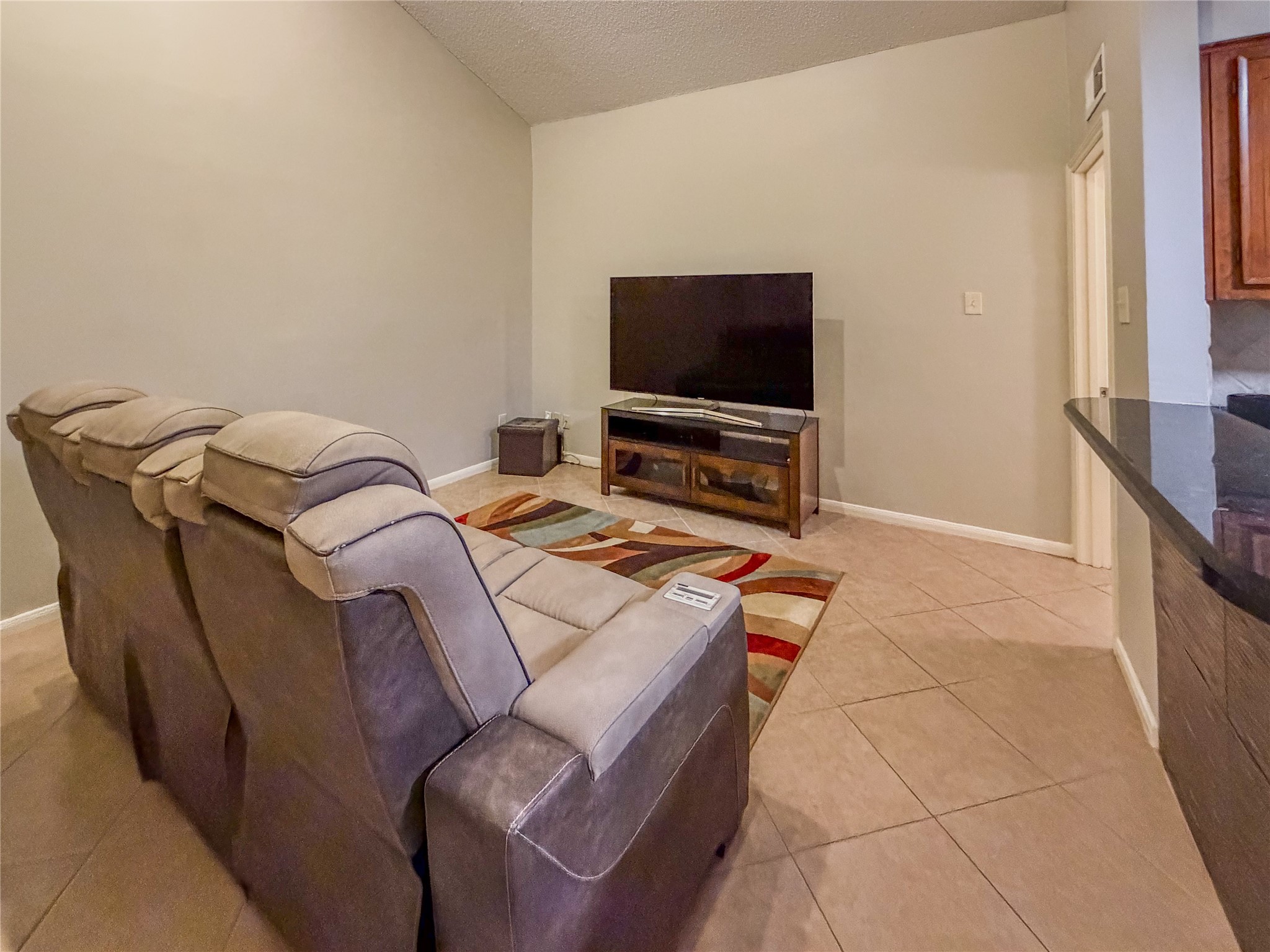 2574 Marilee Lane, Unit 23 Houston, TX 77057 - Photo 3 of 22 Enjoy your favorite movies on a 65-inch 4K TV and entertainment center.
