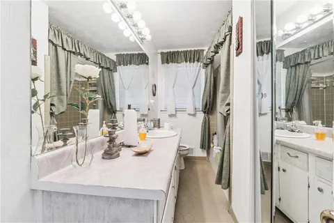 a en suite bathroom with a double vanity sink a mirror and a shower