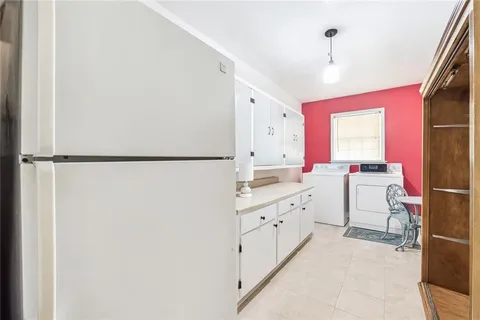 a room with a sink a window and a painting on the wall