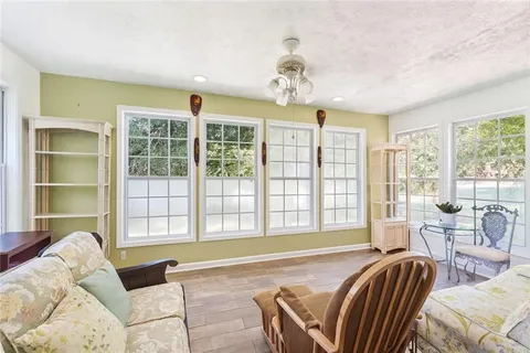 a spacious bedroom with a bed and glass window